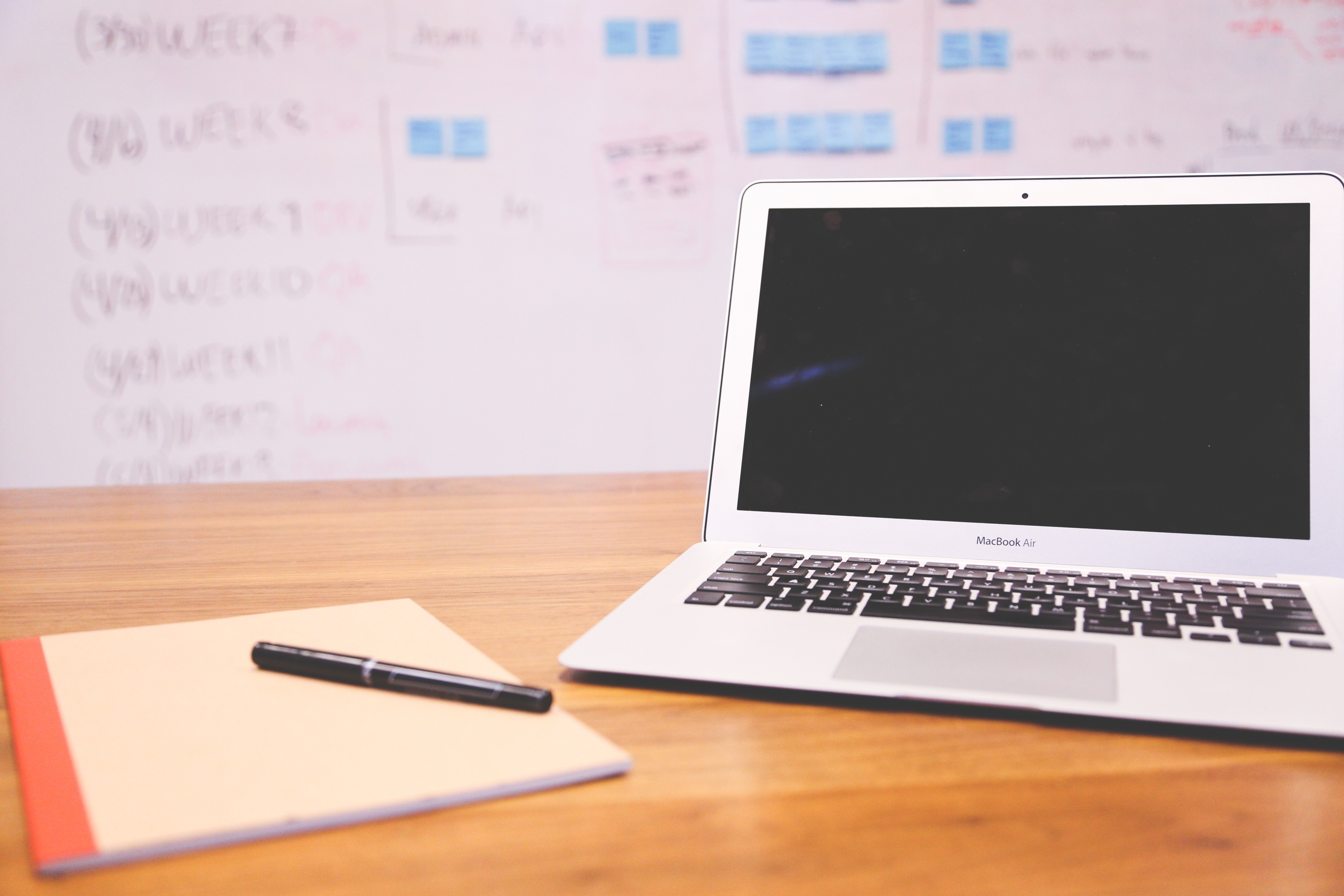 Marketer planning keyword ideas with a notebook and laptop