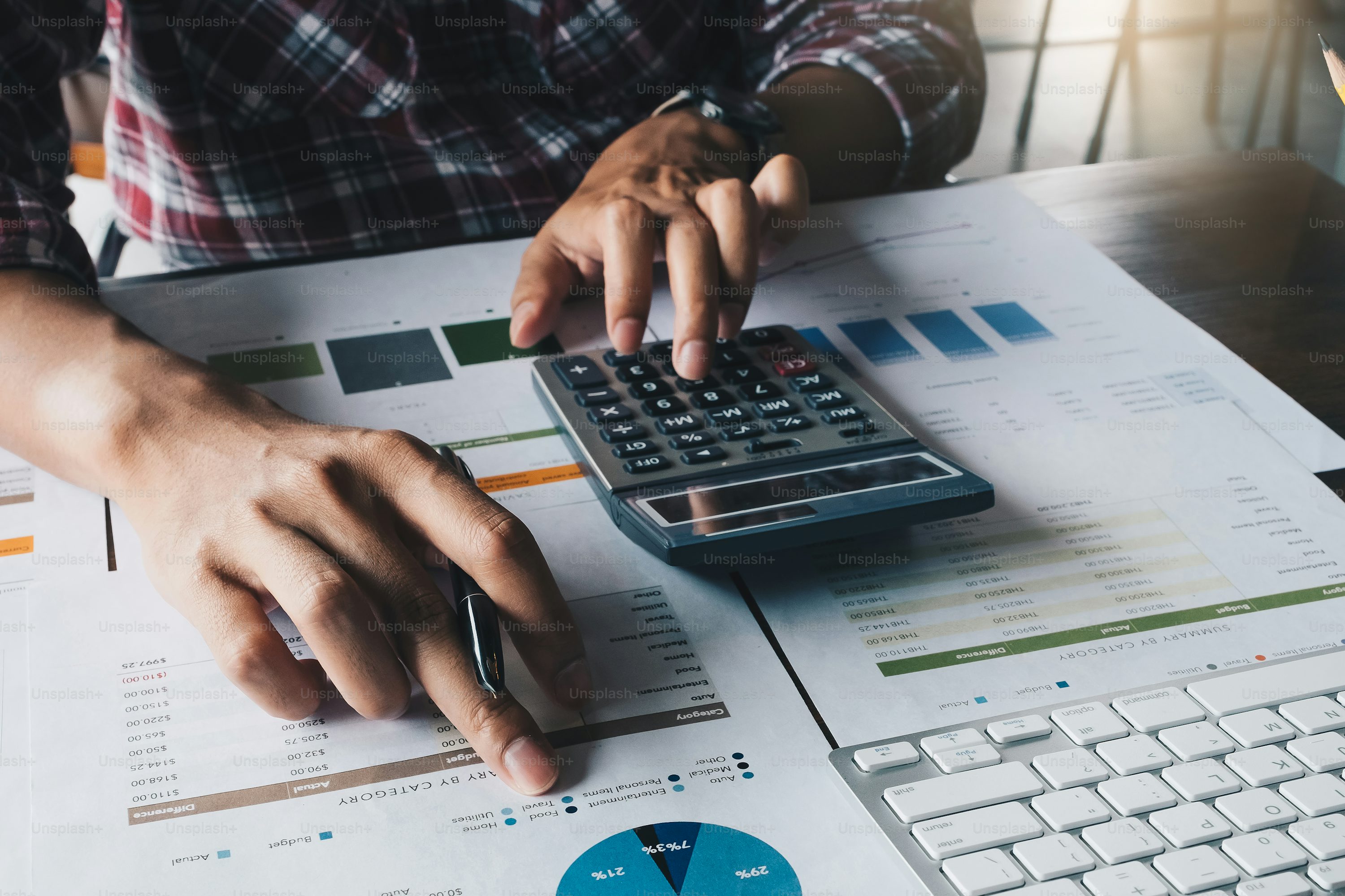 Marketing budget calculations beside a laptop